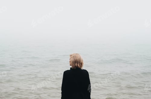 Preview: Woman Contemplates the Foggy Ocean View Outdoors