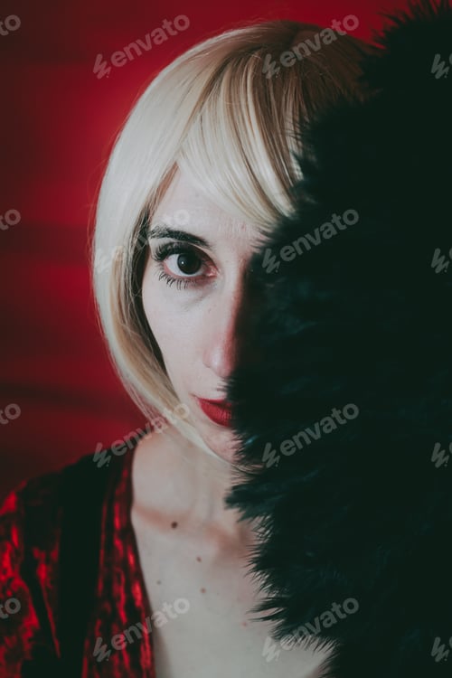 Preview: Vintage style portrait of a blonde woman covering by a hand fan