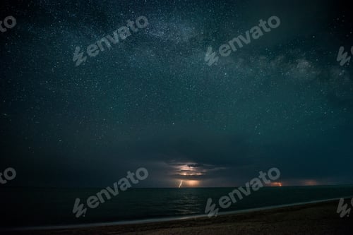 Preview: Starry night with thunderstorm and lightning over the sea