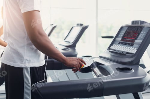 Preview: Closeup man's hands on treadmill