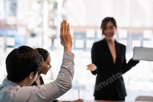 Preview: Close-up. Image businessman raising his hand doubt presentation at the office. Front blur.