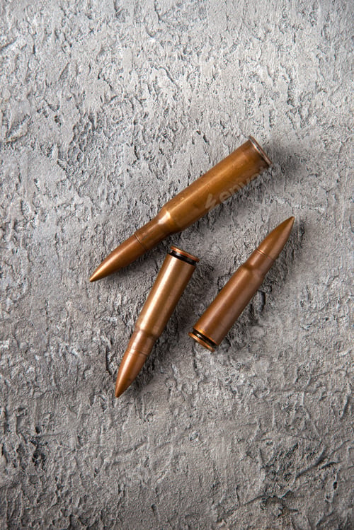 Preview: top view of brown bullets on a white surface tank war death soldier gun