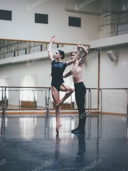 Preview: Man practicing in ballet with partner ballerina woman in black clothing in gym