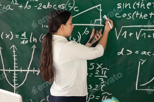 Preview: Girl writes mathematical examples on the school board. solves a geometry problem.