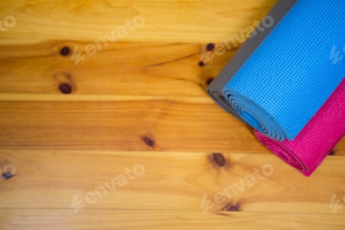 Preview: Yoga Mats Rolled on a Wooden Background