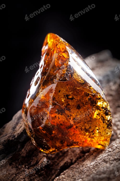 Preview: Natural amber stone. A piece of dirty transparent yellow amber on piece of stoned wood