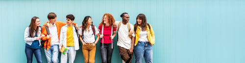 Preview: Diverse college students standing together on a blue wall