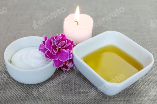 Skincare Products with Candle and Purple Flower