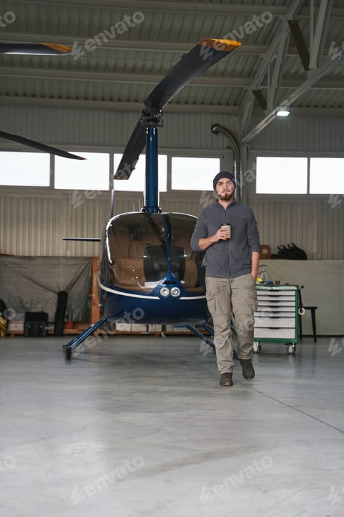 Preview: Bearded man in front of the copter in garage