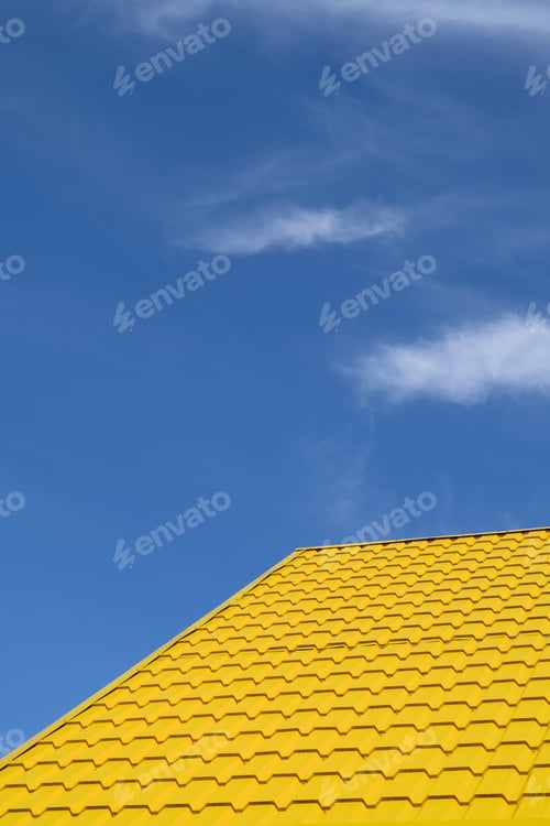Preview: Bright yellow roof of metal roofing against blue sky