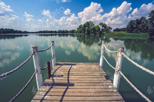 Preview: Small pier in a lake captured on a beautiful sunny day