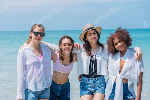 Preview: Happy children laughing and enjoying at beach. Teenage playing with friends at the sea.