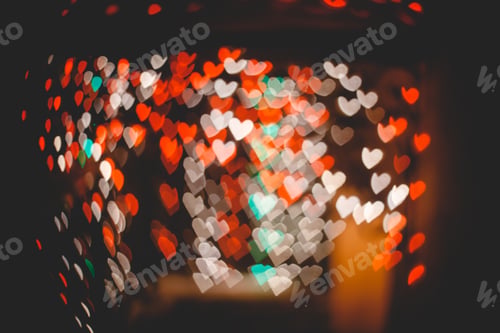 Defocused Heart Shaped Bokeh Lights on Dark Background