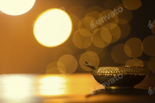 Preview: Diya lamp on dark table, space for text. Diwali celebration