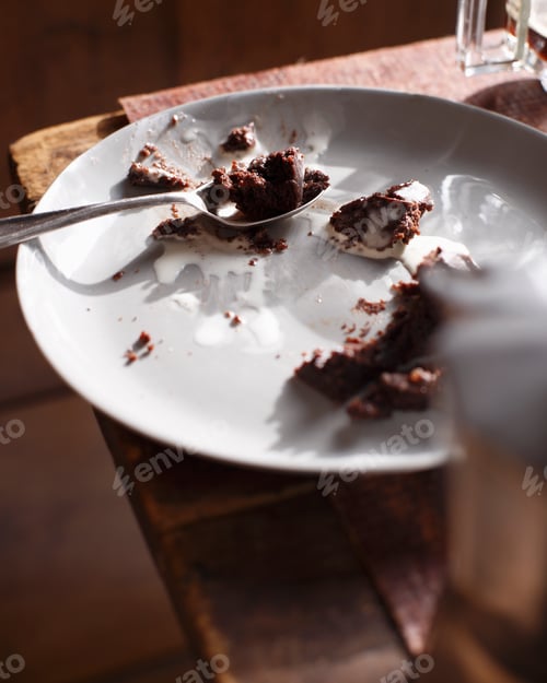 Preview: Cake crumbs on a white plate with a fork.