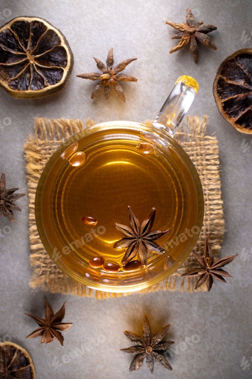 Preview: Vertical shot of a cup of spiced tea with cinnamon