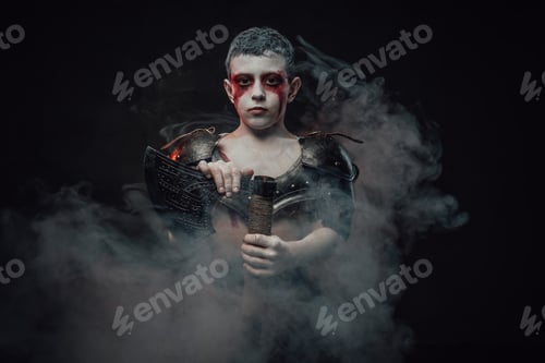 Preview: Cheerful military boy in dark armour with axe in dark background