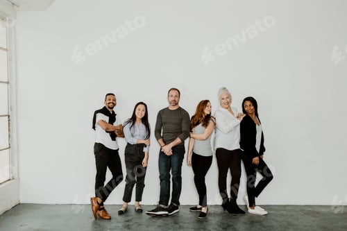 Preview: Group of Colleagues Posing Together in Studio