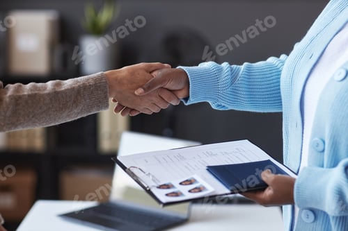 Preview: Focus on handshake of female manager of visa application center and applicant