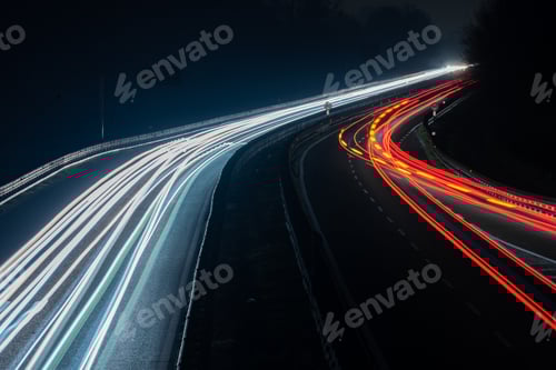Preview: Abstract image of night traffic lights on the road. Car light trails at night in curve asphalt road