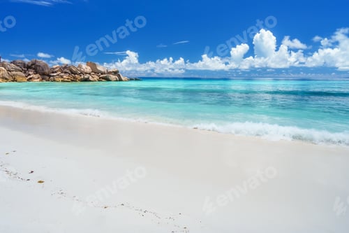 Preview: Grand Anse beach at La Digue island in Seychelles. Sandy beach with shallow blue ocean bay, white