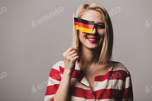 Preview: beatiful girl holds German flag on gray background