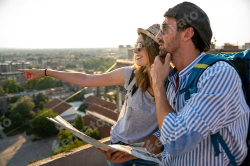 Preview: Happy tourists couple, friends sightseeing city with map together. Travel people concept.