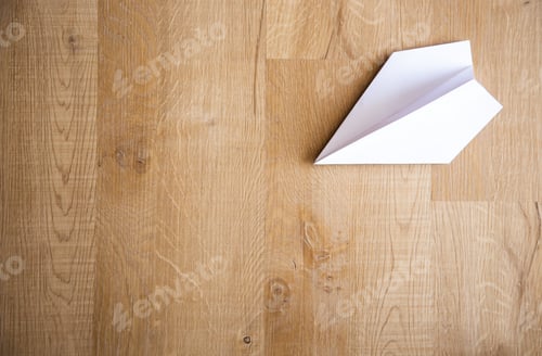 Preview: paper plane on wooden floor