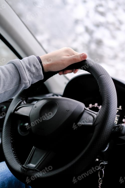 Preview: Man's hands on the steering wheel of a car while driving