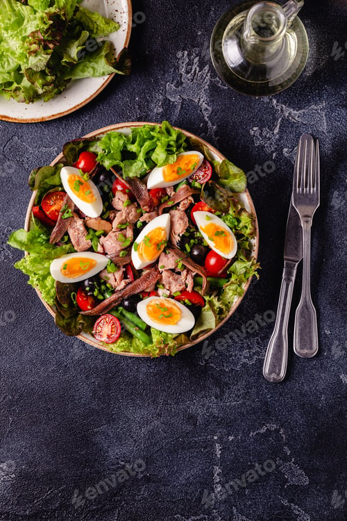 Preview: salad Nicoise with tuna, eggs, green beans, tomatoes, olives, lettuce and anchovies