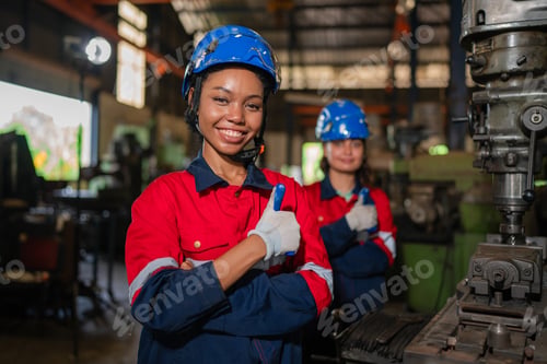 Preview: Portrait of female automation engineer standing in modern industrial factory.
