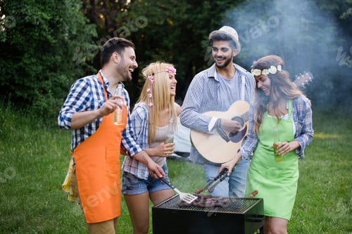 Preview: Group of happy people standing around grill, chatting, drinking and eating