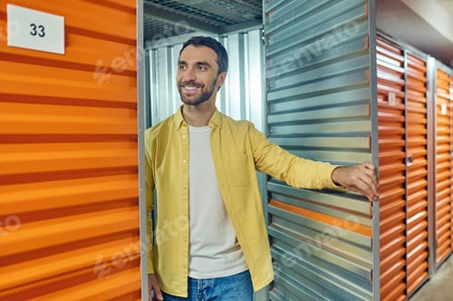 Preview: Cheerful man standing near garage door