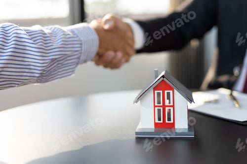 Preview: Real estate agents businessmen shake hands after the signing of the contract agreement is complete.