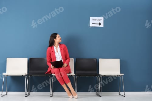 Preview: Young woman waiting for job interview, indoors