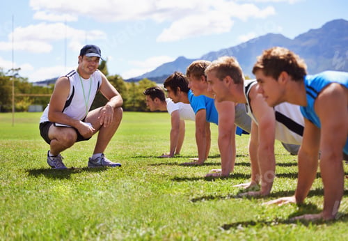 Preview: Whos the best. Young sportsmen training outdoors with a coach.