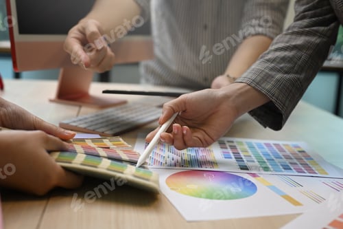 Preview: Graphic designers team working with color swatches and brainstorming for new project.