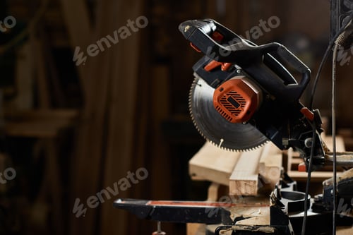 Preview: sharp miter saw in a rustic cozy workshop filled with wood