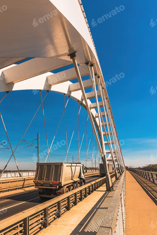 Preview: Truck with tipper semi trailer crossing the bridge