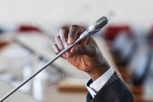 Preview: Businessman speaking in microphone
