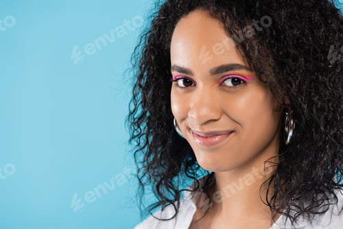 Preview: portrait of brunette african american woman with makeup and perfect skin looking at camera isolated