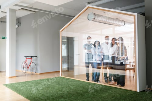Preview: Portrait of confident business team in modern office behind glass wall