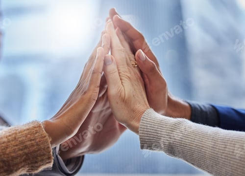 Preview: Together we can do this. Shot of a group of businesspeople high fiving each other.