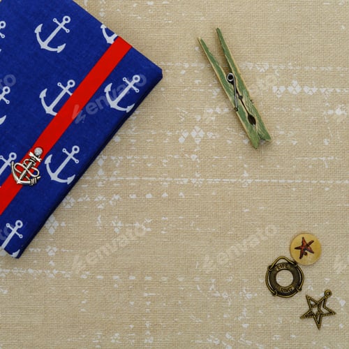 Preview: Small notebook with ancor design lying on paper