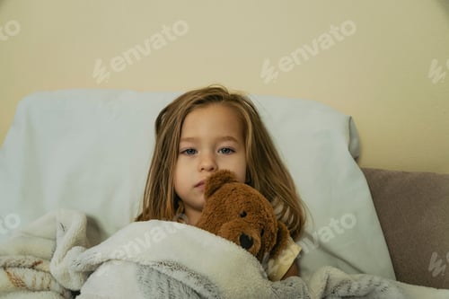 Preview: Portrait of sad sick little girl looking to the camera