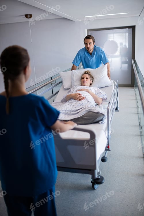 Preview: Team of doctors taking pregnant woman to operation theatre