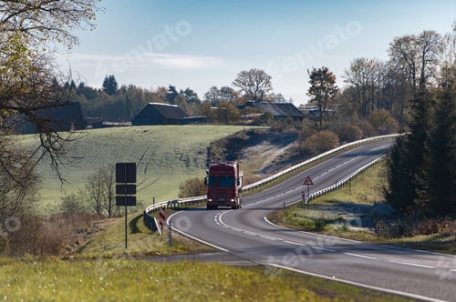 Preview: Front view of a truck on a bend in an autumn road