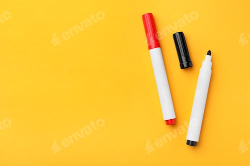 Preview: Bright color markers on orange background, flat lay. Space for text