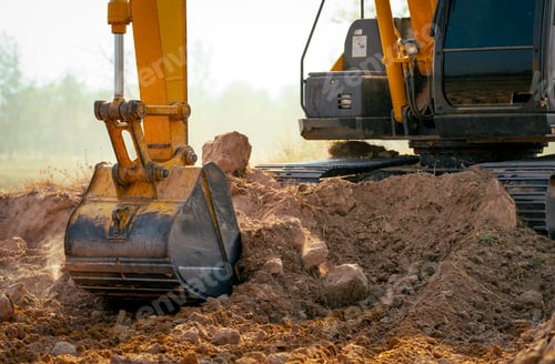 Preview: Closeup bucket of backhoe digging the soil at construction site. Crawler excavator digging