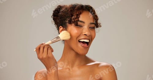 Preview: Woman, studio and happy with makeup brush for foundation and cosmetics application on gray backgrou